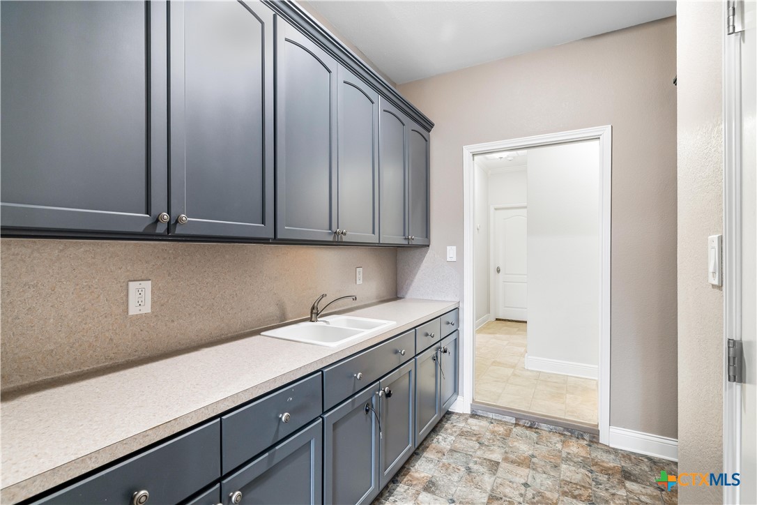 1118 East Maxwell Ditch Road Port Lavaca, TX 77979 - Photo 28 of 36 a kitchen with a sink and cabinets