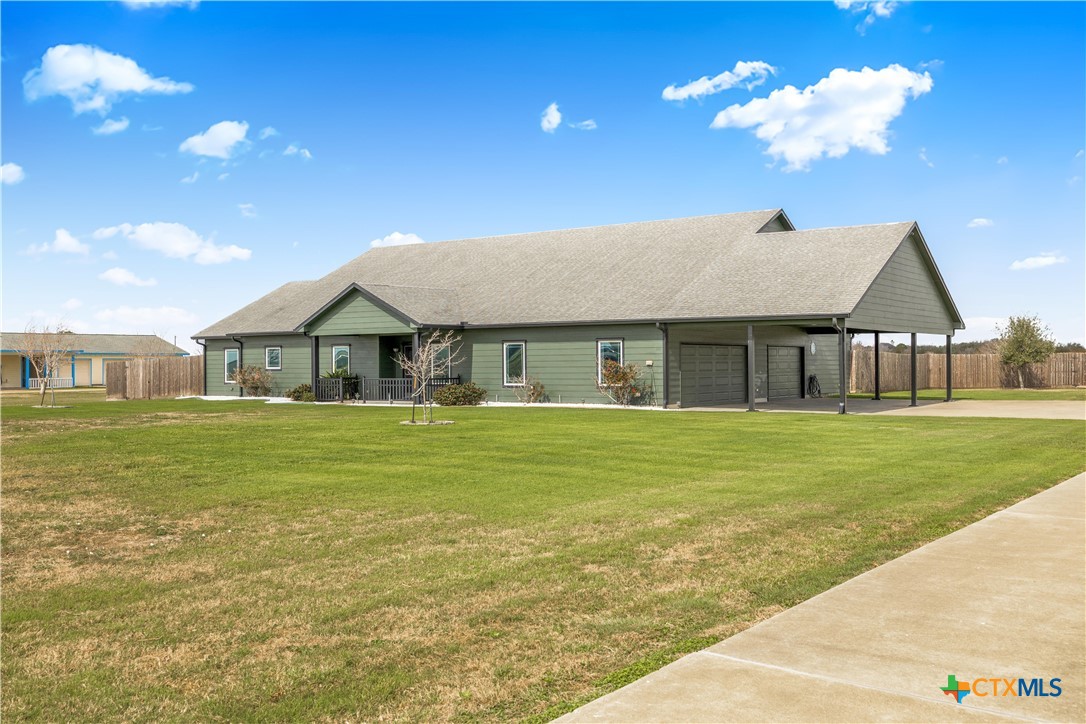 1118 East Maxwell Ditch Road Port Lavaca, TX 77979 - Photo 3 of 36 a front view of a house with a garden