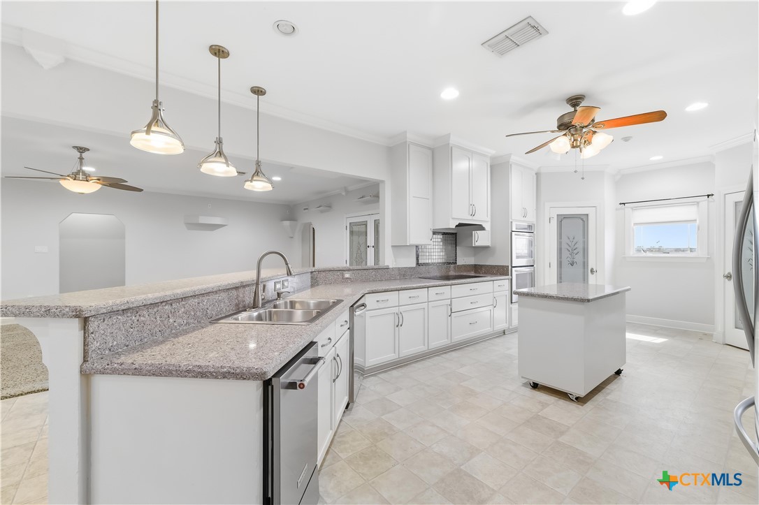 1118 East Maxwell Ditch Road Port Lavaca, TX 77979 - Photo 9 of 36 a kitchen with a sink counter top space appliances and cabinets