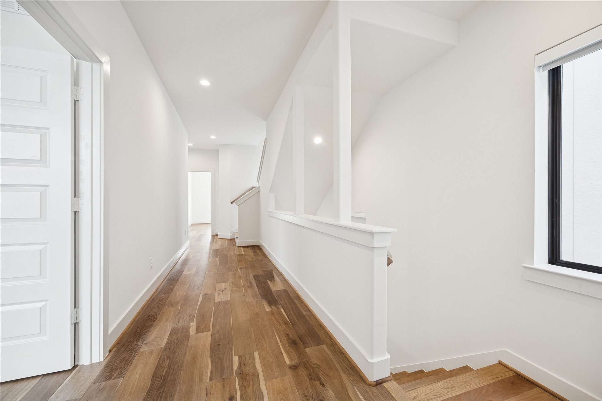 1739 Ojeman Point Lane Houston, TX 77055 - Photo 24 of 35 Second-floor landing with hallway access to two secondary bedrooms connected by a Jack-and-Jill bathroom.