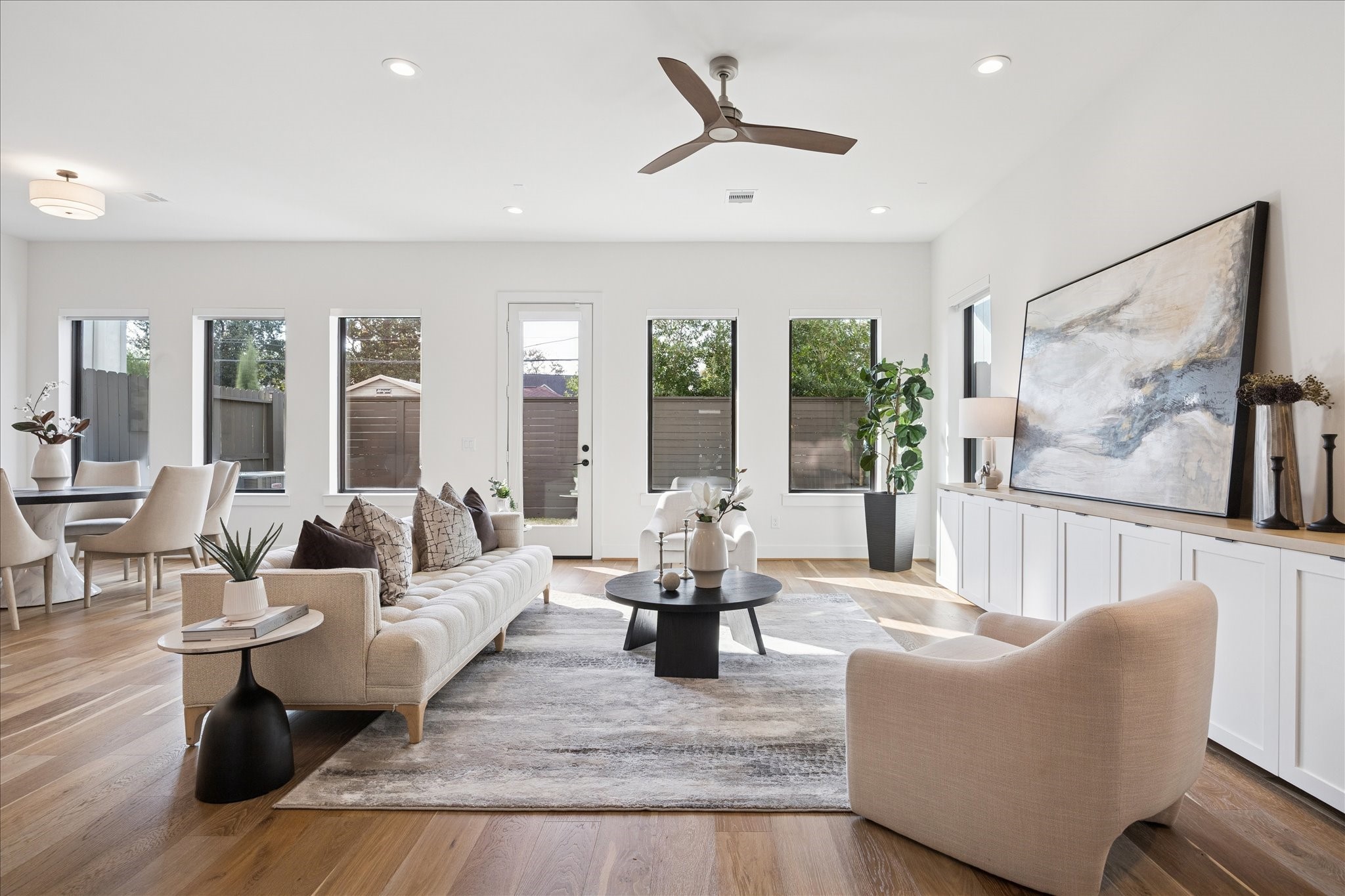 1739 Ojeman Point Lane Houston, TX 77055 - Photo 5 of 35 Light-filled living room featuring French oak wood floors and a refined, neutral palette, complemented by an air scrubber integrated into the HVAC system for enhanced indoor air quality.
