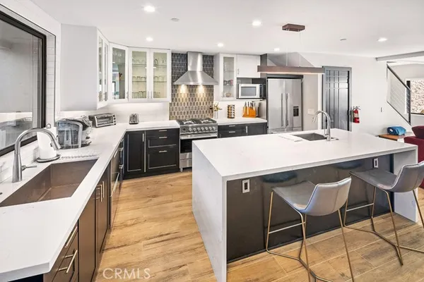 a large kitchen with kitchen island a stove a sink and a refrigerator