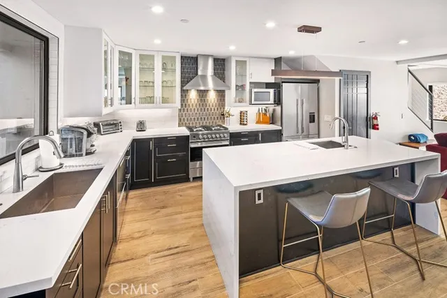 a large kitchen with kitchen island a stove a sink and a refrigerator