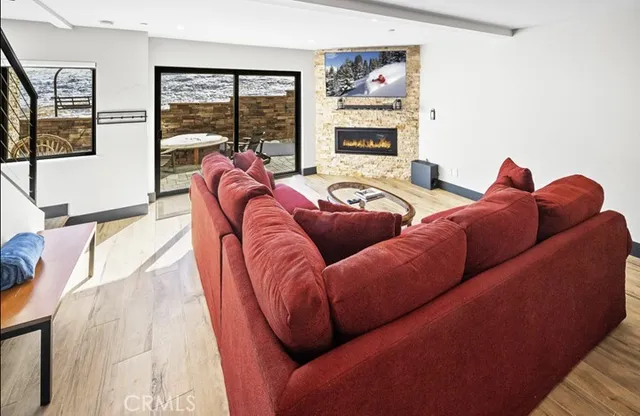 a kitchen with stainless steel appliances a refrigerator a sink a stove a oven a dining table and chairs