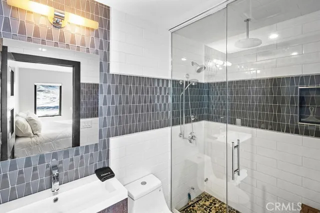 a bedroom with a bed and painting on the wall