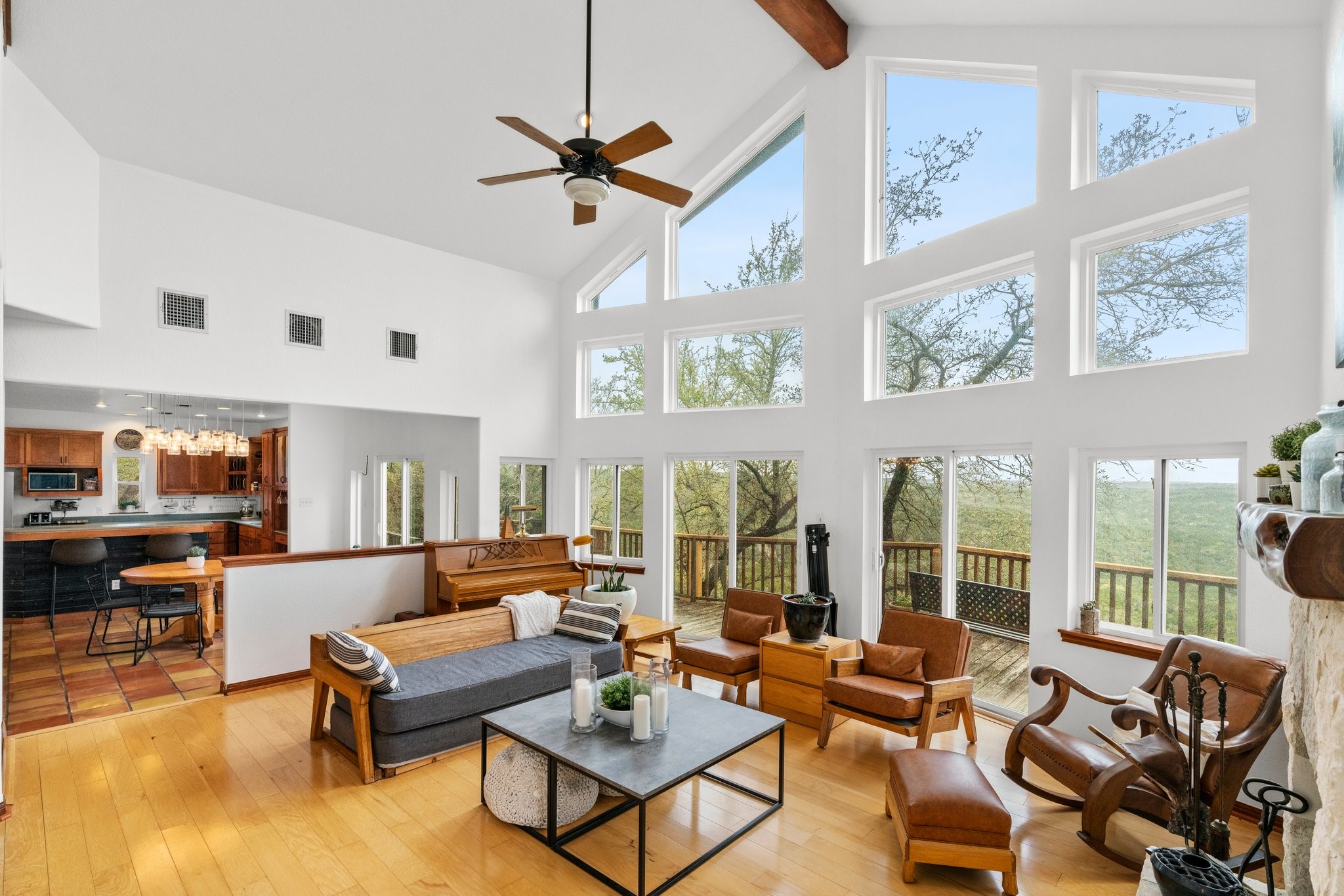 The angle showcases the wood flooring in the living room and the serene view you get from the wall of windows.