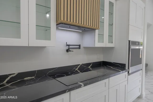 a kitchen with a sink and cabinets