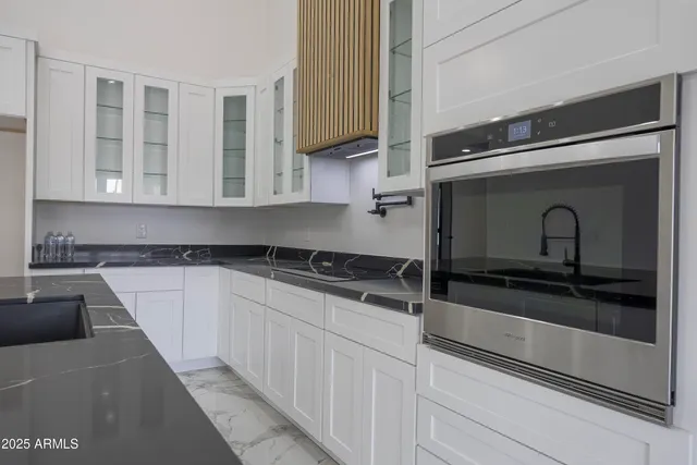a kitchen with stainless steel appliances granite countertop a sink and cabinets