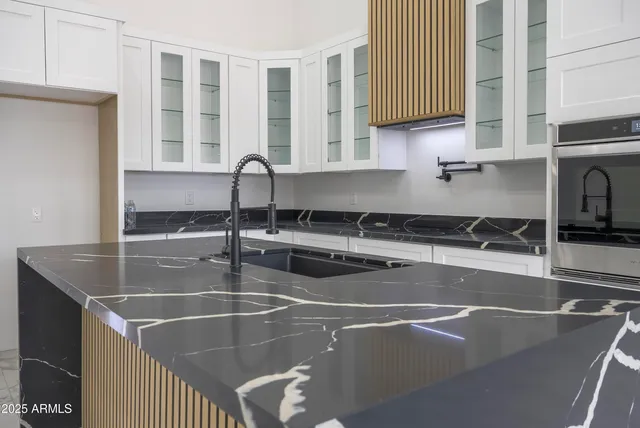 a kitchen with a sink a counter and cabinets
