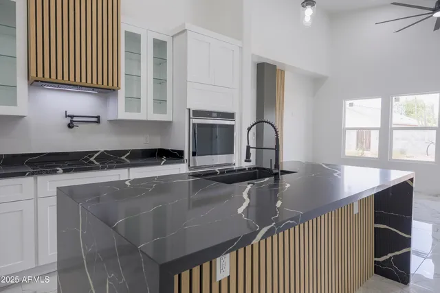 a kitchen with a sink appliances and cabinets