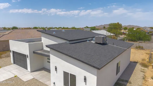 an aerial view of residential houses with outdoor space