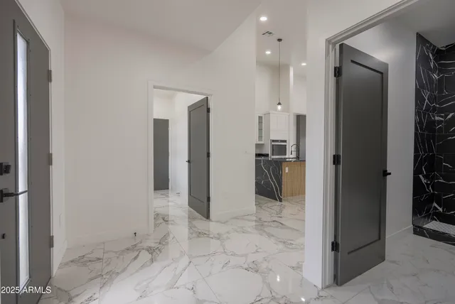 a view of a hallway with wooden shelves