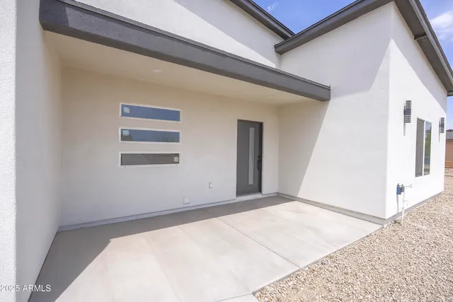 a view of a big room with wooden floor and windows