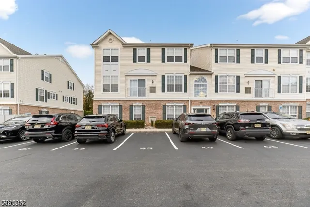 a couple of cars parked in front of a building