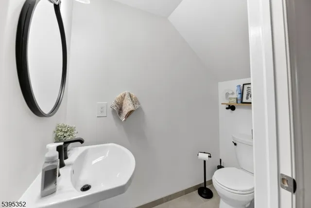 a bathroom with a sink toilet and a mirror