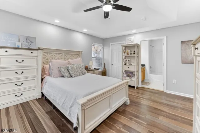 a bed room with a bed and a ceiling fan
