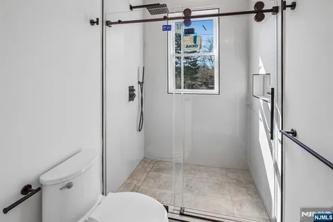 a bathroom with a shower toilet and sink