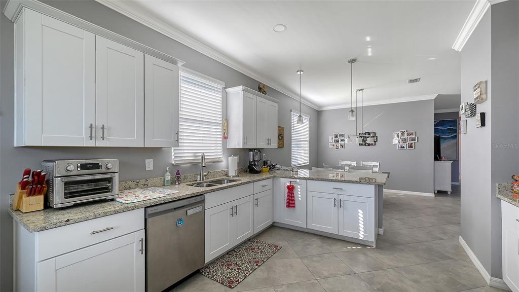19625 Fishhawk Trail Venice, FL 34293 - Photo 11 of 38 a kitchen with a sink stove and cabinets