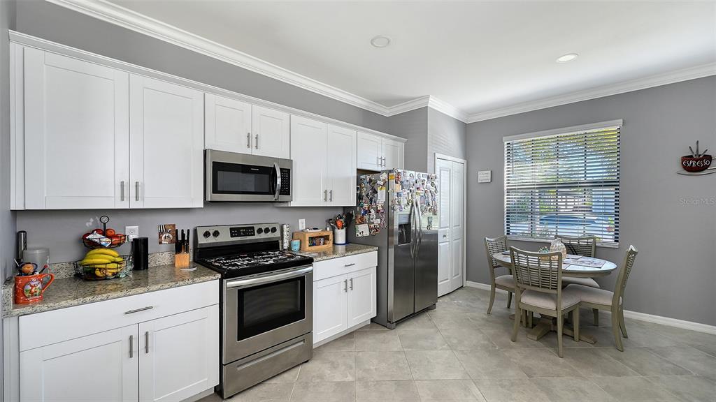 19625 Fishhawk Trail Venice, FL 34293 - Photo 12 of 38 a kitchen with stainless steel appliances a stove a sink and a refrigerator