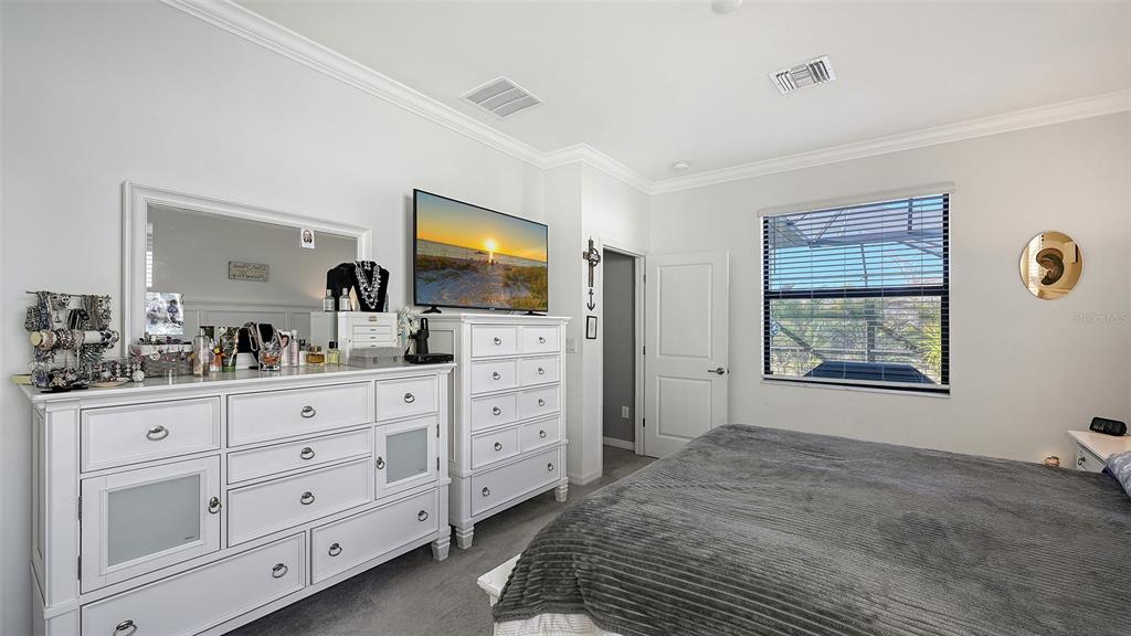19625 Fishhawk Trail Venice, FL 34293 - Photo 14 of 38 a spacious bedroom with a bed a mirror and dresser