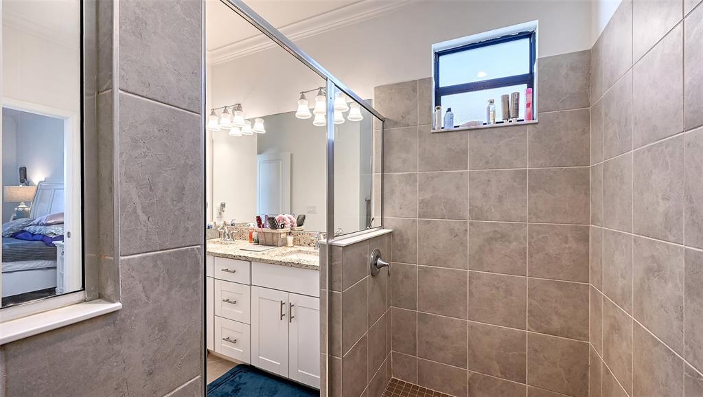 19625 Fishhawk Trail Venice, FL 34293 - Photo 16 of 38 a bathroom with a granite countertop sink a toilet and a mirror