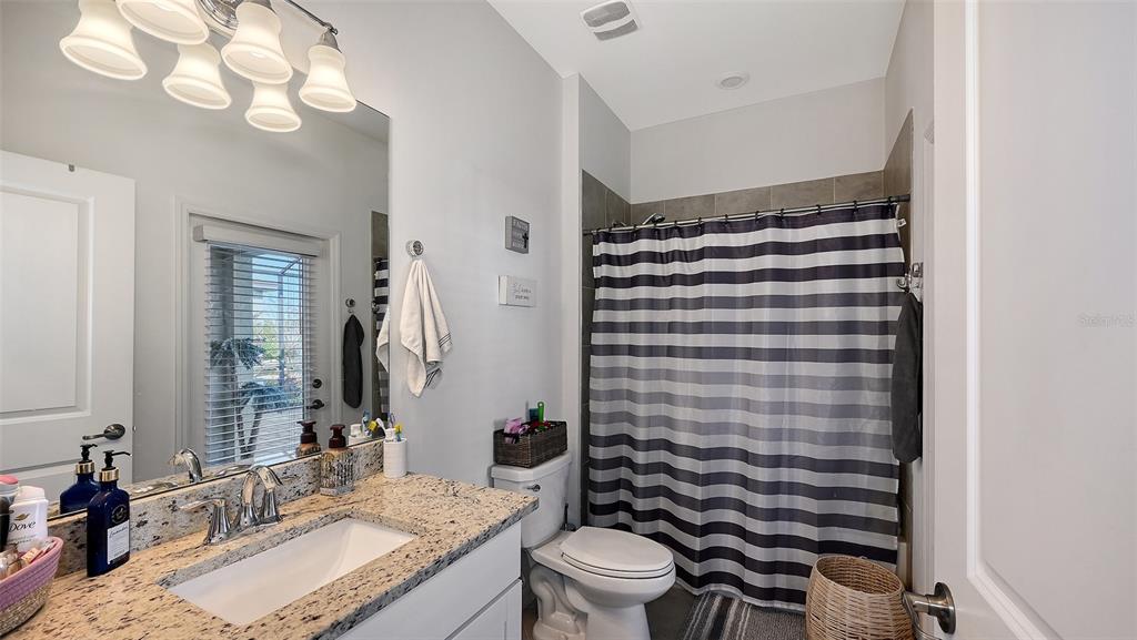 19625 Fishhawk Trail Venice, FL 34293 - Photo 19 of 38 a bathroom with a granite countertop sink toilet and shower