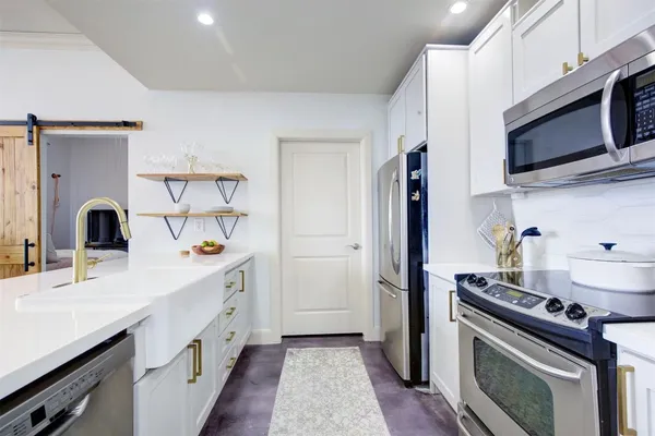 a kitchen with a sink and a stove top oven