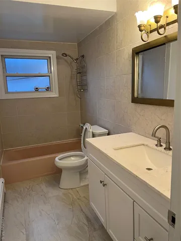 a bathroom with a sink a toilet and mirror