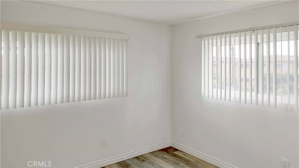 1724 Crofton Lane Escondido, CA 92027 - Photo 16 of 22 a view of an empty room with wooden floor and a window
