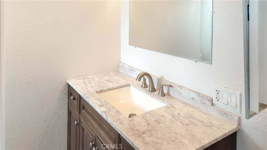 1724 Crofton Lane Escondido, CA 92027 - Photo 20 of 22 a bathroom with a granite countertop sink and a mirror