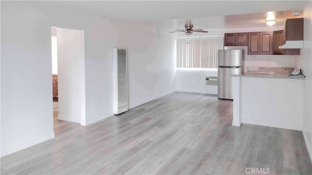 1724 Crofton Lane Escondido, CA 92027 - Photo 3 of 22 a view of kitchen and empty room with wooden floor