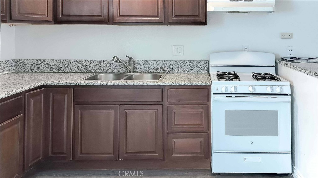 1724 Crofton Lane Escondido, CA 92027 - Photo 6 of 22 a kitchen with granite countertop cabinets stainless steel appliances and sink