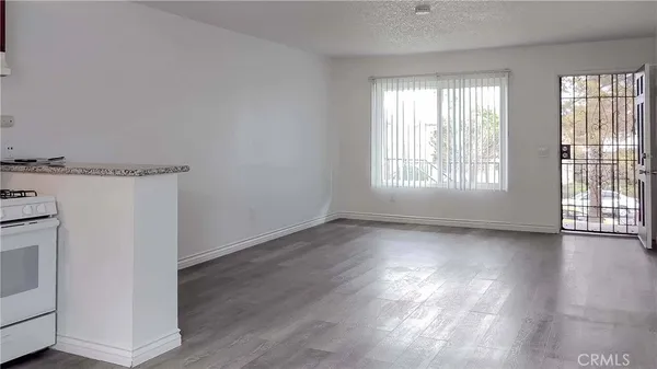 a view of a kitchen with wooden floor and windows