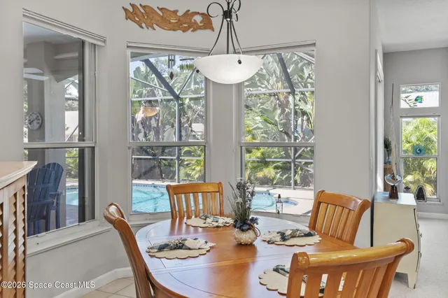 a view of a dining room with furniture wooden floor and a chandelier