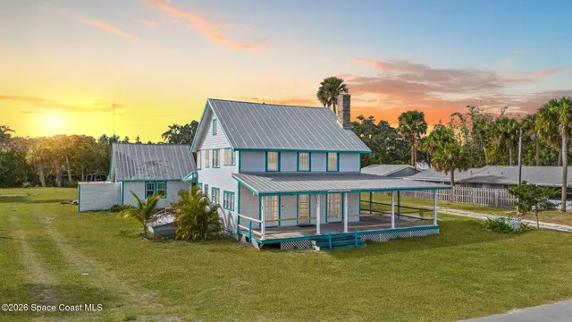 a view of a house with pool and a yard