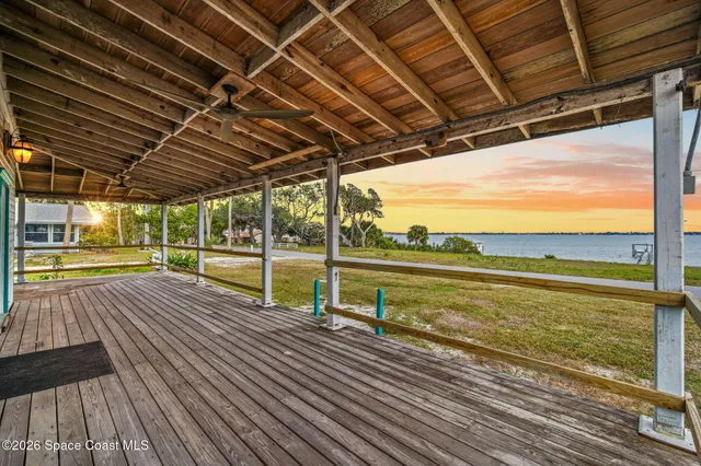 a view of a balcony with wooden floor
