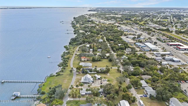 an aerial view of a house with a lake view