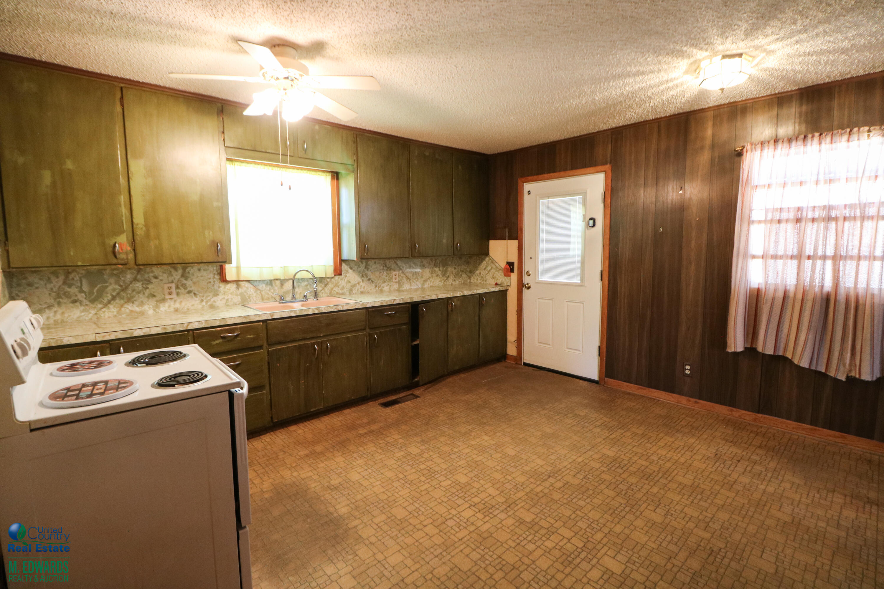 404 Wilson Street Sudan, TX 79371 - Photo 6 of 10 a kitchen with stainless steel appliances granite countertop a sink stove and refrigerator