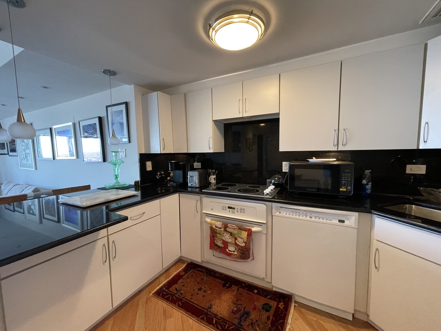 175 East Delaware Place, Unit 5403 Chicago, IL 60611 - Photo 5 of 20 a kitchen with granite countertop a sink a stove and cabinets