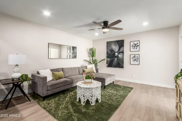 a living room with furniture and a wooden floor