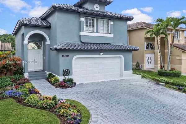 a front view of a house with a garden