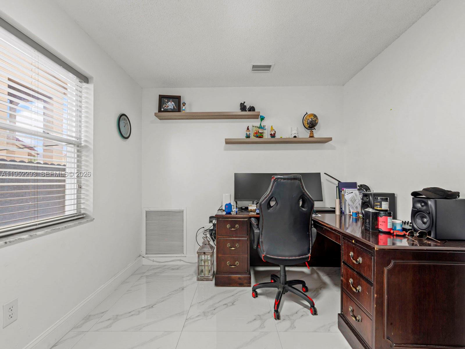 15626 Southwest 100th Terrace Miami, FL 33196 - Photo 13 of 30 a view of a workspace with furniture and a window
