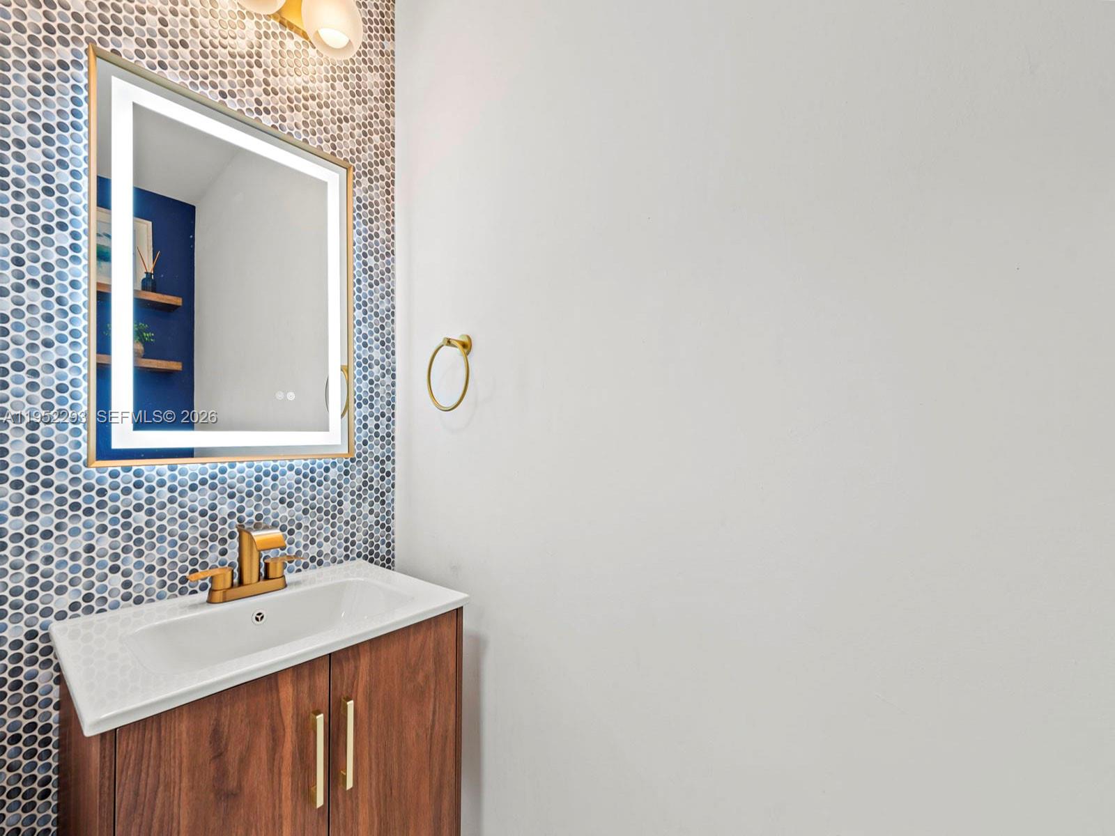 15626 Southwest 100th Terrace Miami, FL 33196 - Photo 15 of 30 a bathroom with a sink and a mirror