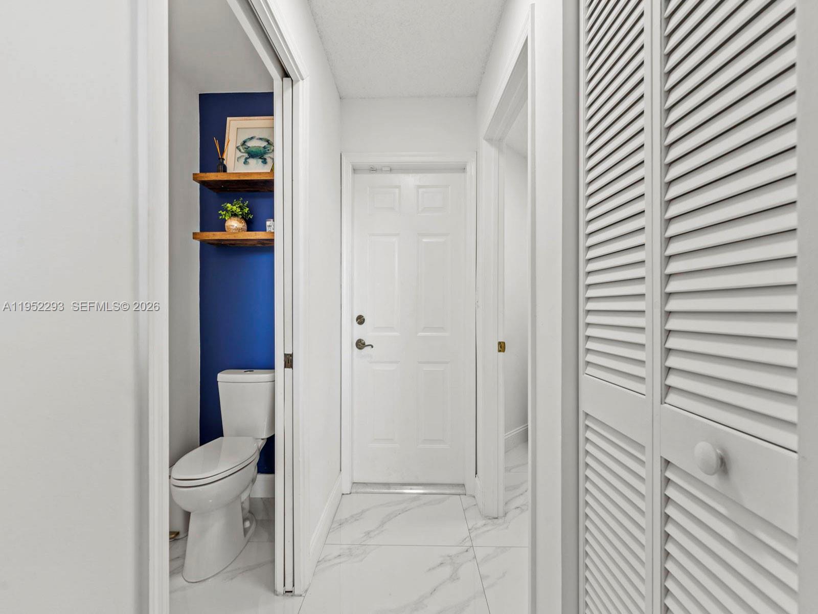 15626 Southwest 100th Terrace Miami, FL 33196 - Photo 16 of 30 a white toilet sitting next to a bathroom sink