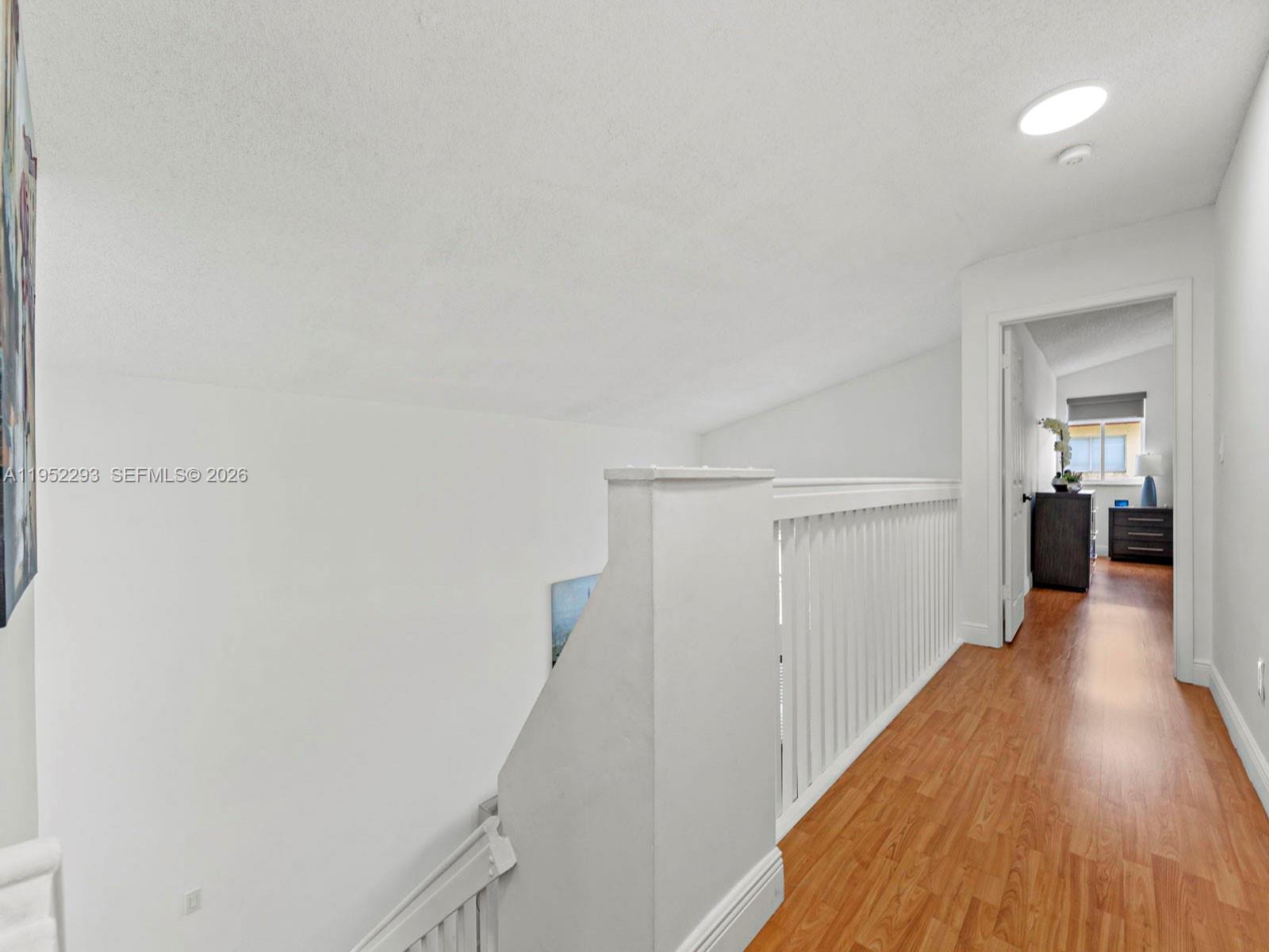 15626 Southwest 100th Terrace Miami, FL 33196 - Photo 18 of 30 a view of a hallway with wooden floor