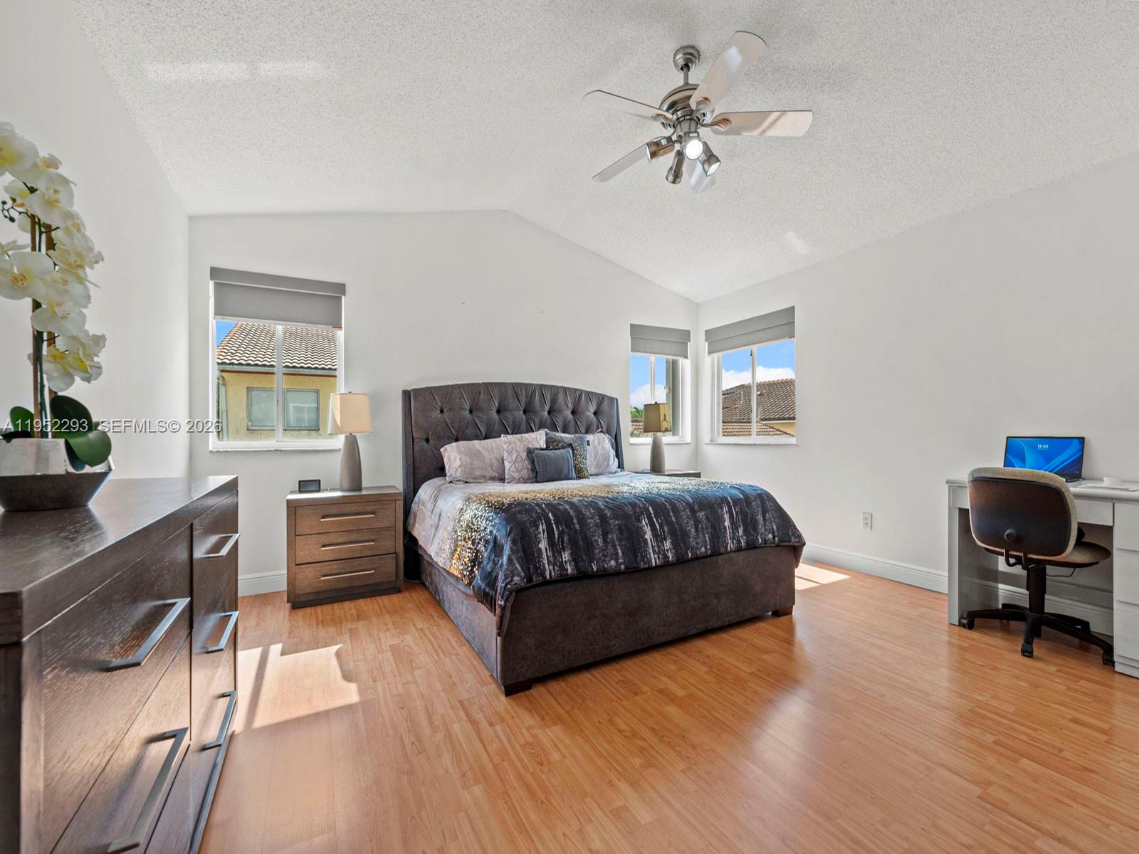 15626 Southwest 100th Terrace Miami, FL 33196 - Photo 19 of 30 a bedroom with a bed and a chair in it