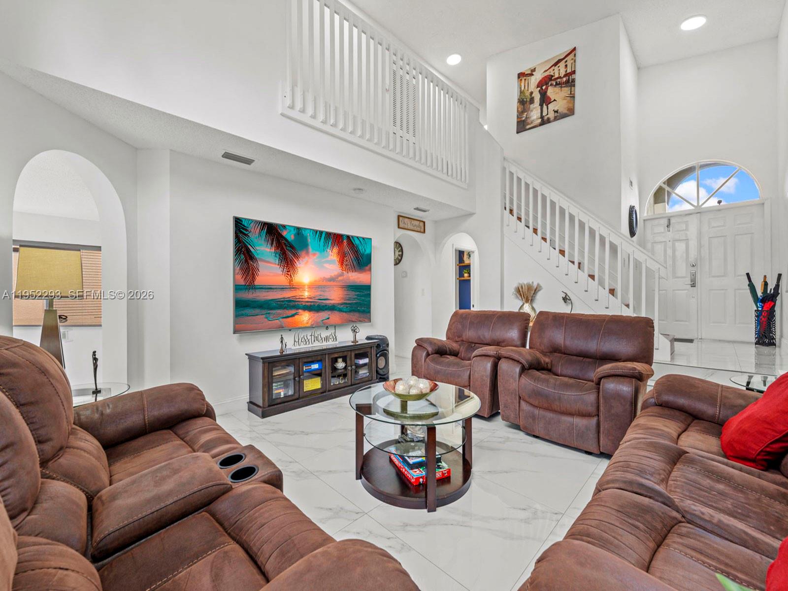 15626 Southwest 100th Terrace Miami, FL 33196 - Photo 2 of 30 a living room with furniture and a flat screen tv