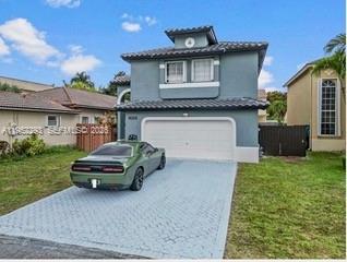 15626 Southwest 100th Terrace Miami, FL 33196 - Photo 2 of 30 a car parked in front of a house