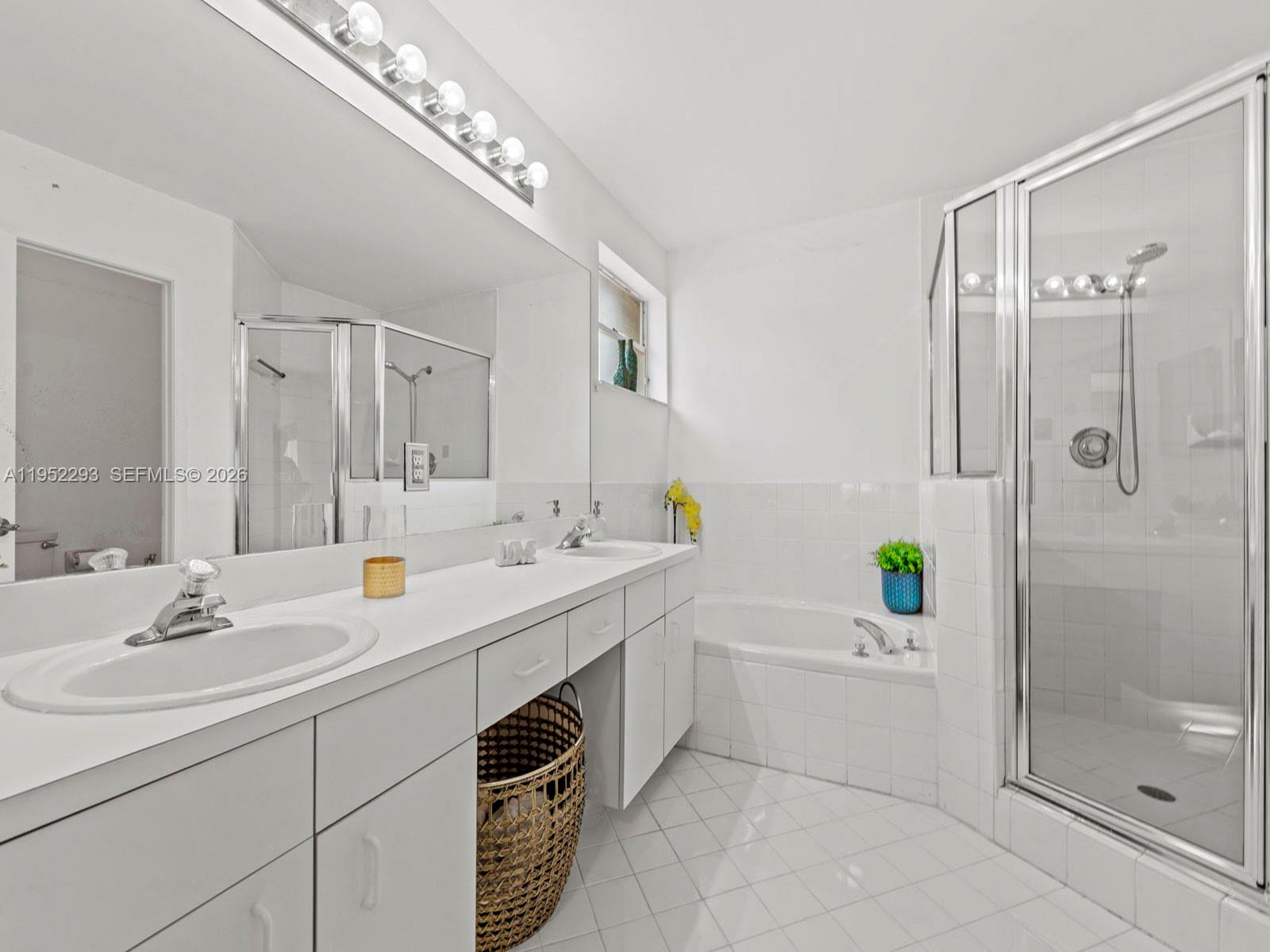 15626 Southwest 100th Terrace Miami, FL 33196 - Photo 22 of 30 a bathroom with a sink double vanity and shower