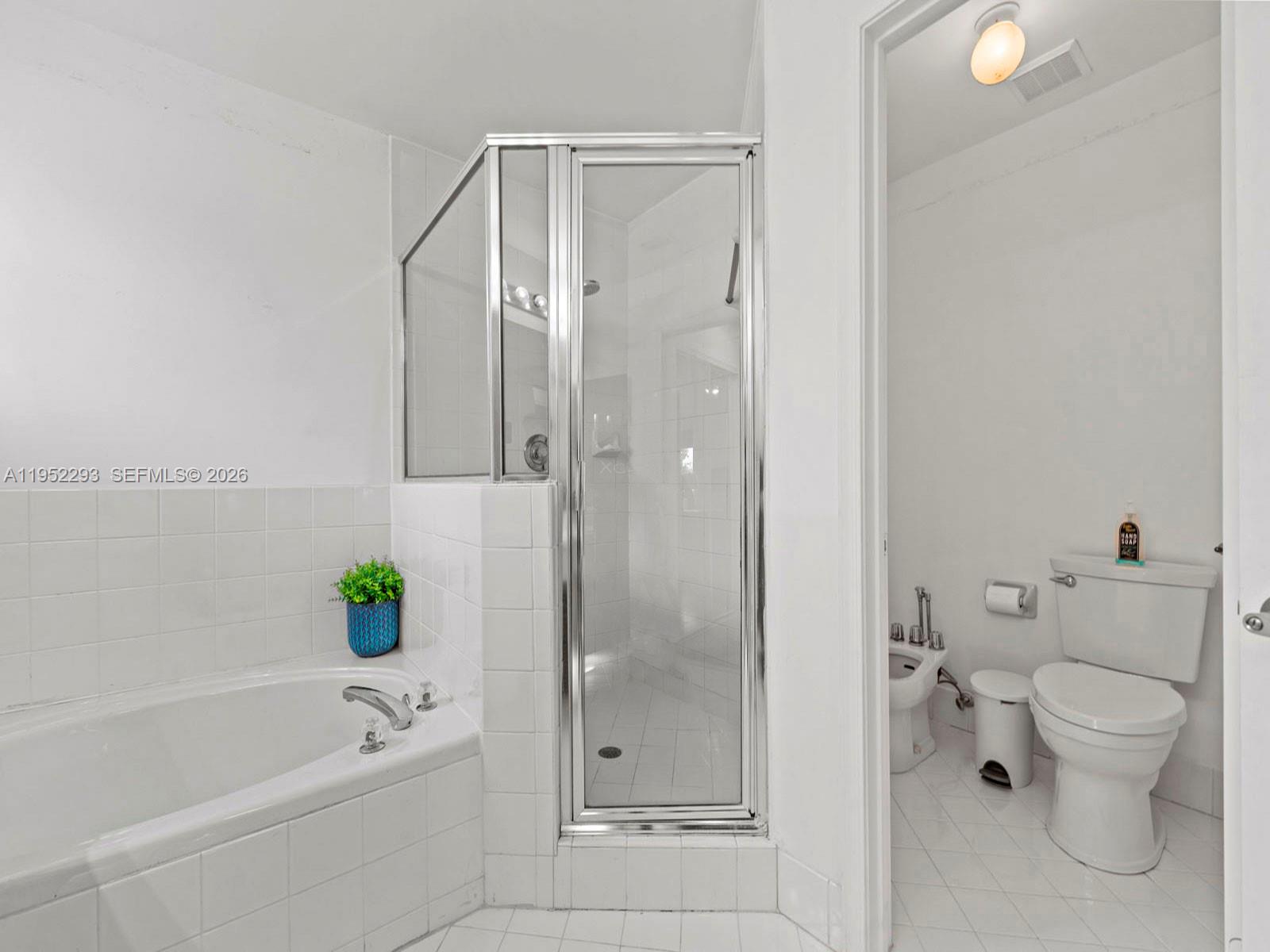 15626 Southwest 100th Terrace Miami, FL 33196 - Photo 23 of 30 a bathroom with a bathtub and a shower